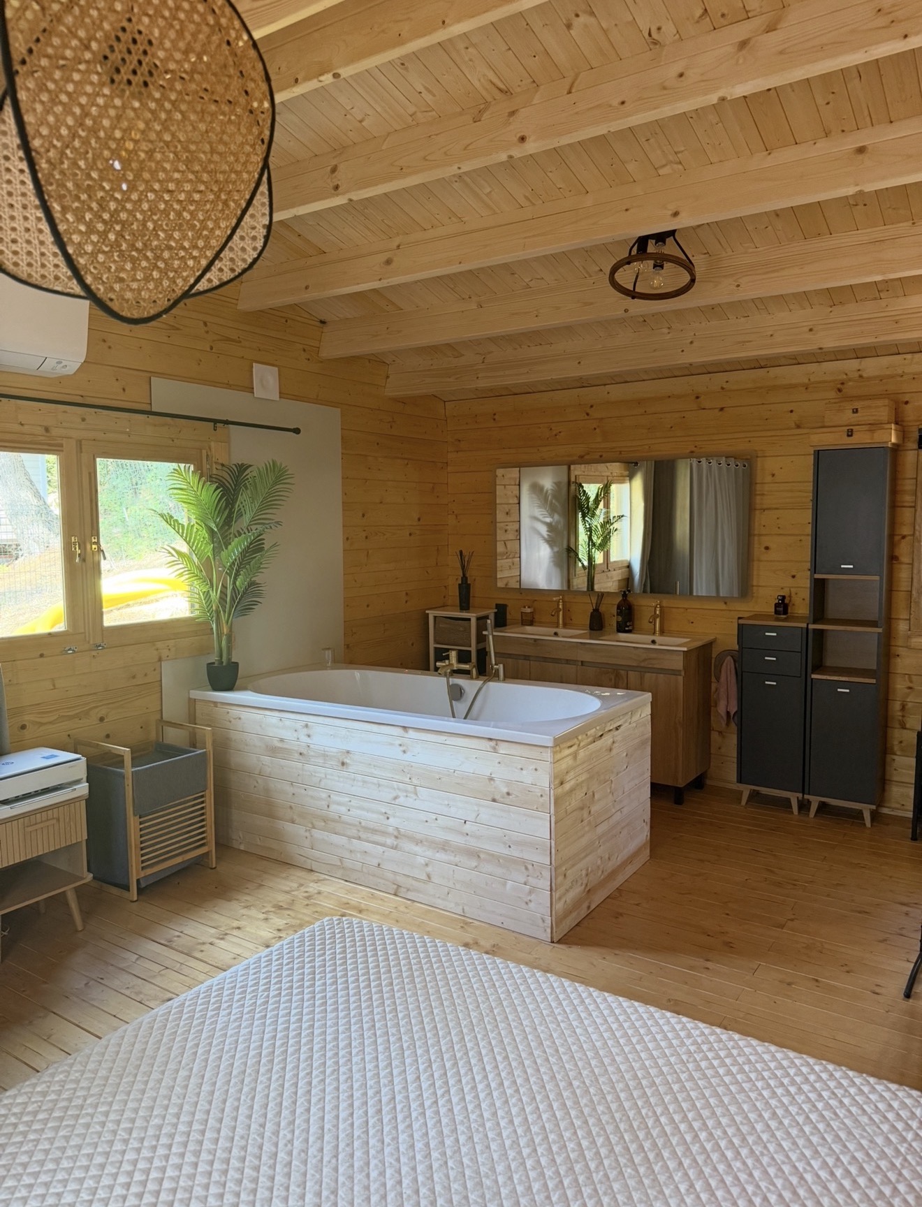 Salle de bain d'un chalet du domaine avec baignoire îlot en bois
